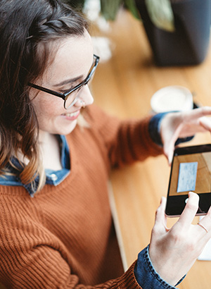 Woman scanning check with cellphone