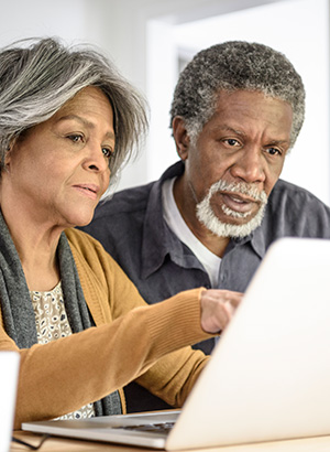 Mature couple looking at laptop