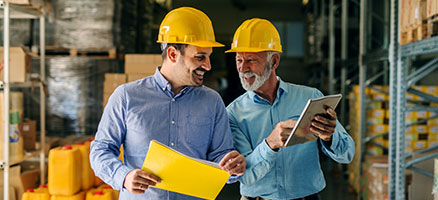 two men in hard hats in warehouse