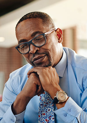 Man in tie sitting.