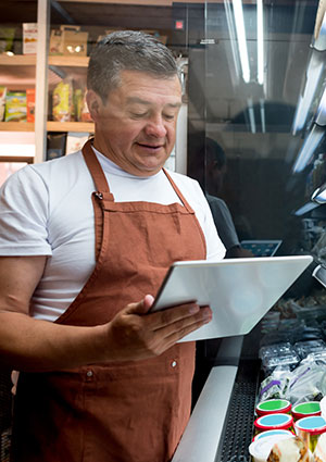 Man taking inventory at grocery store.